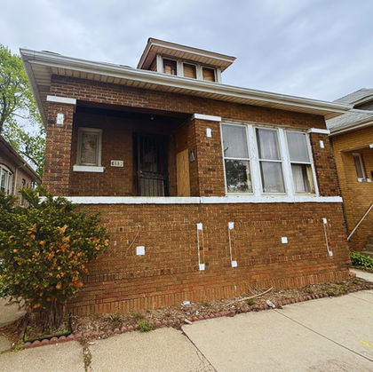 HomeTrade purchased this Auburn Gresham property despite fire damage, code violations, and demolition proceedings. The property transferred as-is without repairs.