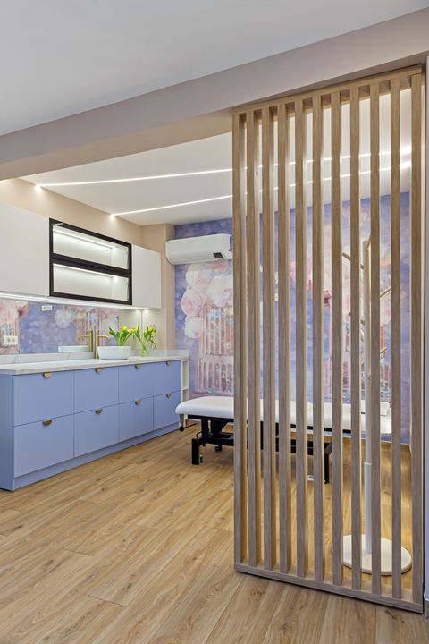 Spațiu tratament cu mobilier albastru și perete lemn, amenajare cabinet The City Clinic 01.