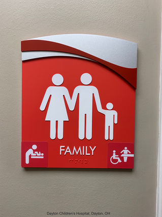 family restroom sign with universal changing table