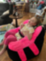 little girl in pea pod chair