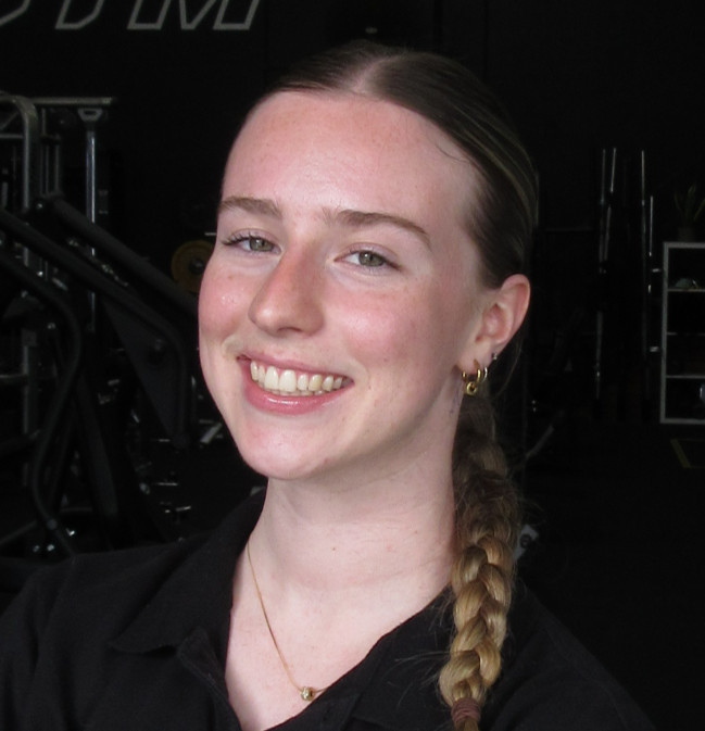 Smiling Abby Chatman "Massage Therapist" in a gym