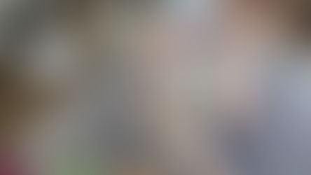 Child on a rug using letter-to-picture puzzles, connecting the 'S' and 'O' puzzle pieces to the corresponding picture cards (Snail, Owl)