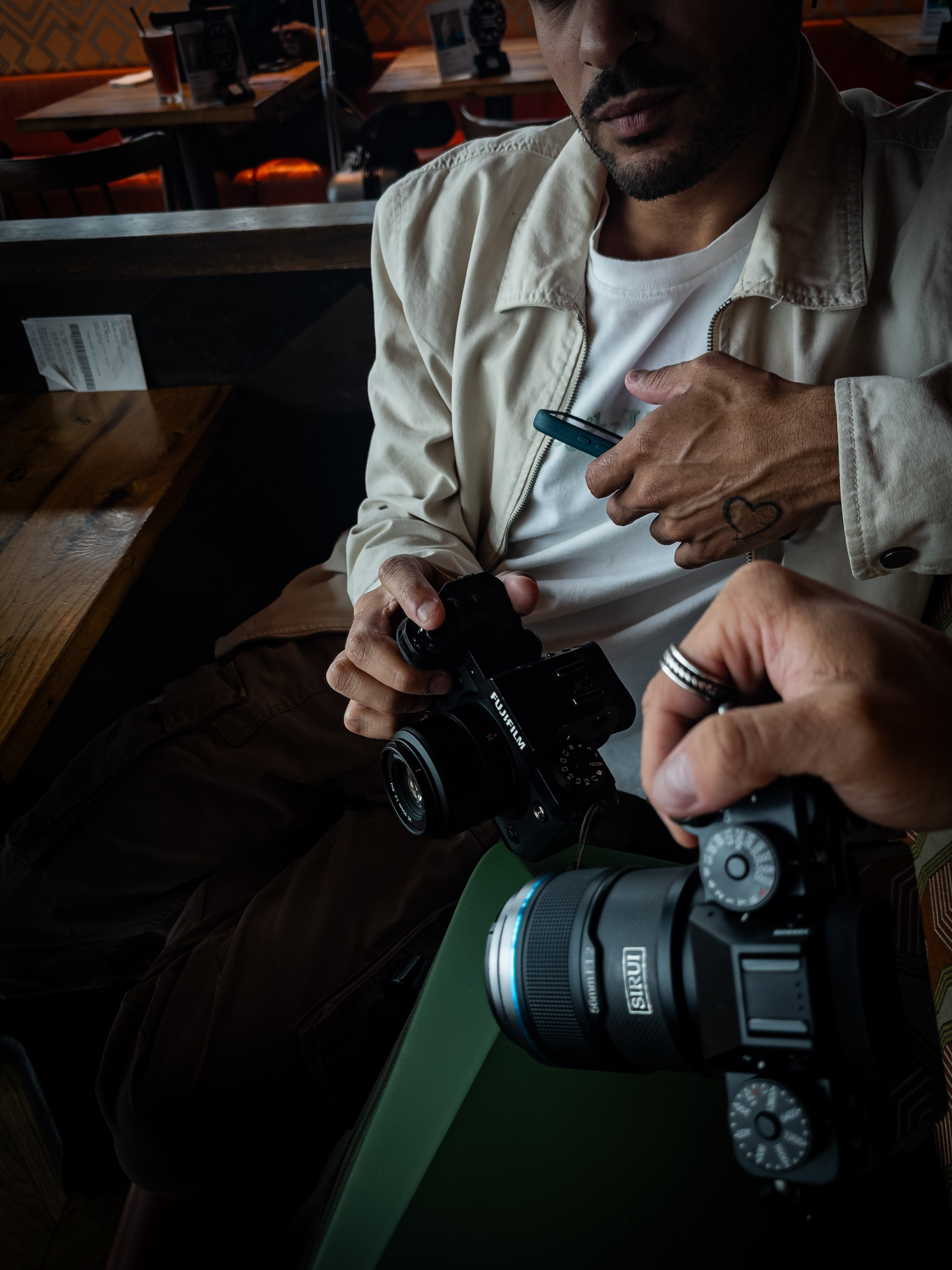 two men holding fujifilm cameras