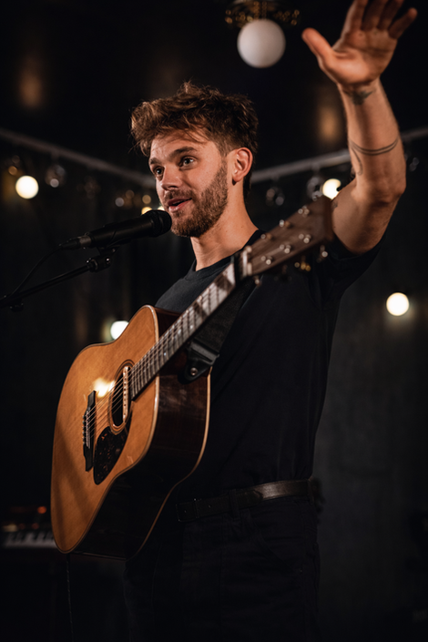 Photograph of guitarist at a concert.