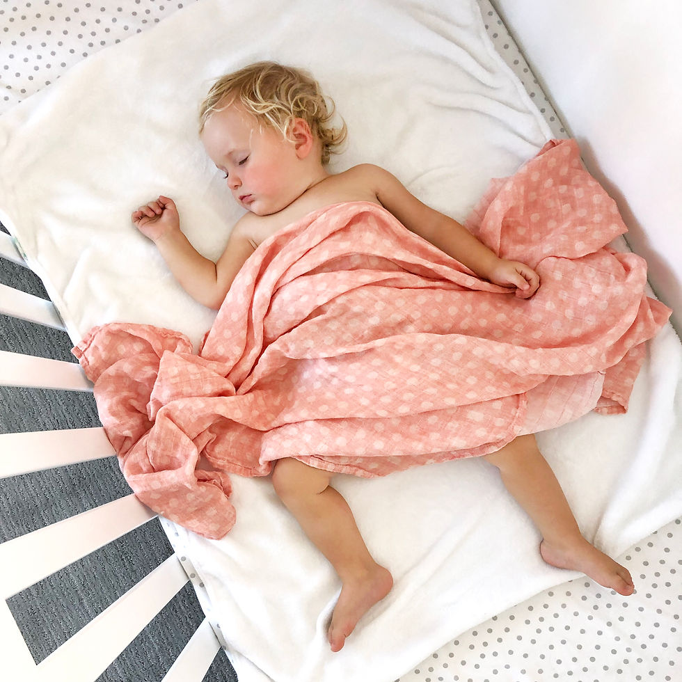 Thumbnail: Sleeping toddler wrapped in a pink swaddle, resting on a white pillow