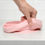 Thumbnail: Hand folding a pink silicone baby plate on a white countertop surface.