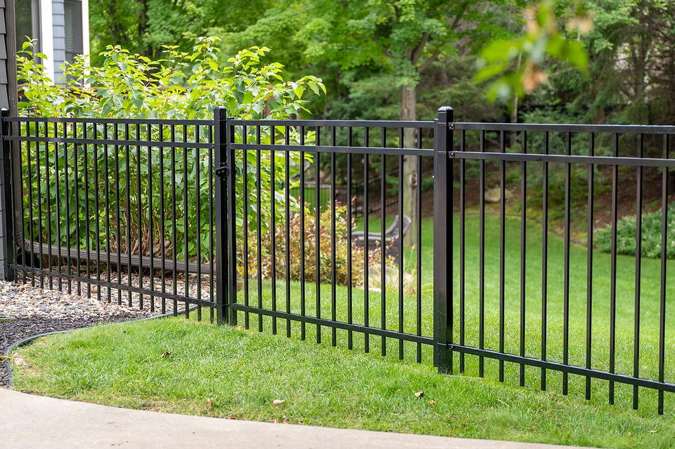 Black aluminum fence panels with vertical pickets along grassy property line in Cold Springs, CA
