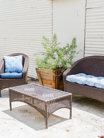 a 4-piece outdoor wicker conversation set, typically featuring a brown resin wicker finish