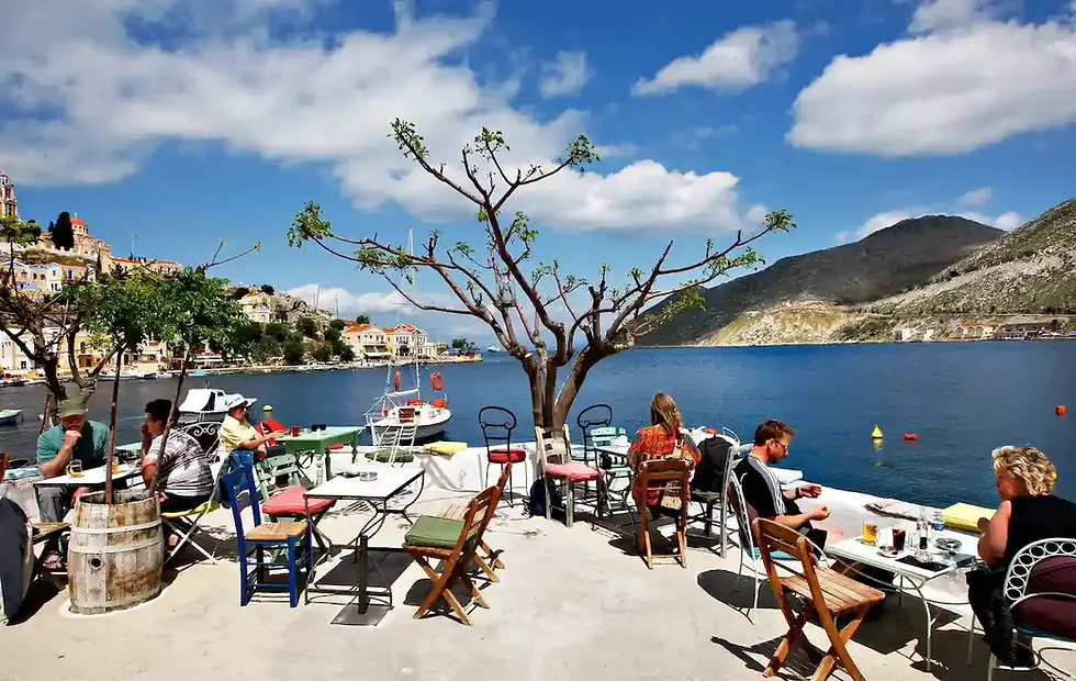 Travelers enjoying a scenic waterfront destination, representing analyzing travel expectations before choosing a trip.