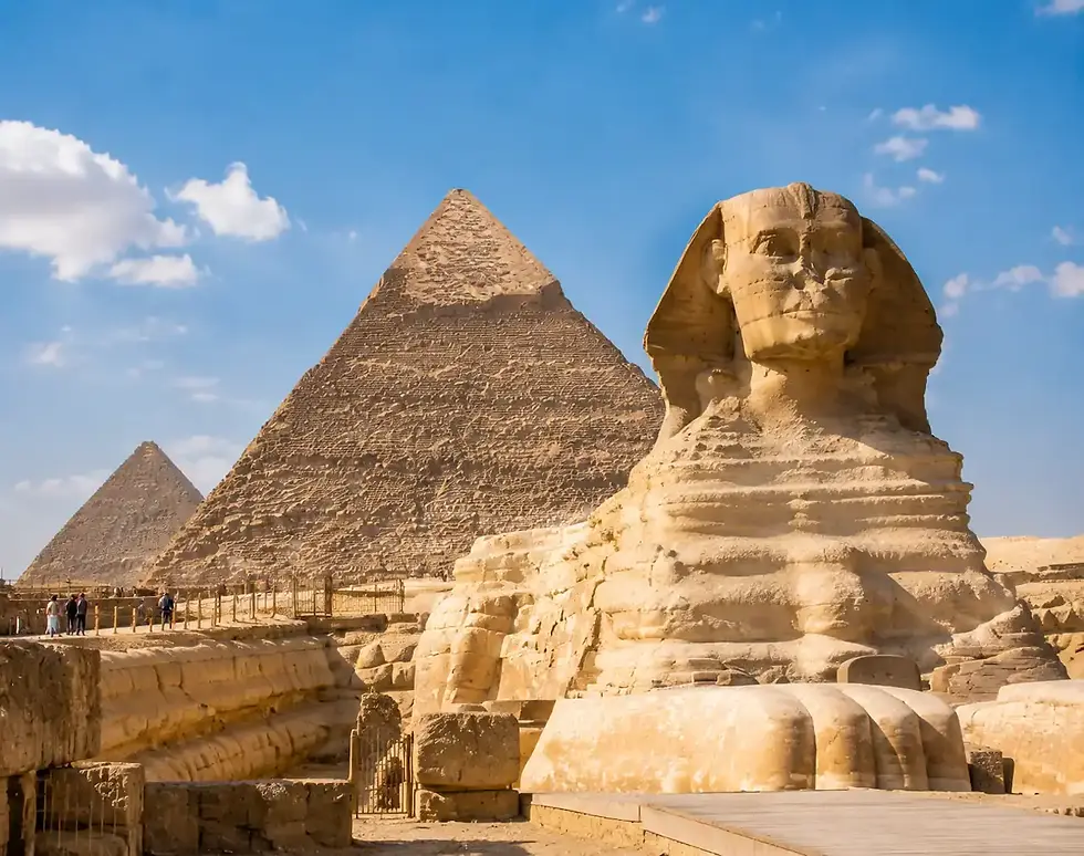 Great Sphinx and Giza pyramids in Cairo with ancient Egyptian ruins under a clear blue sky.