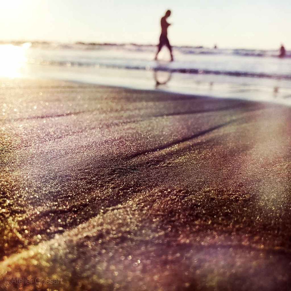 Person walking on Gordon beach at sunset