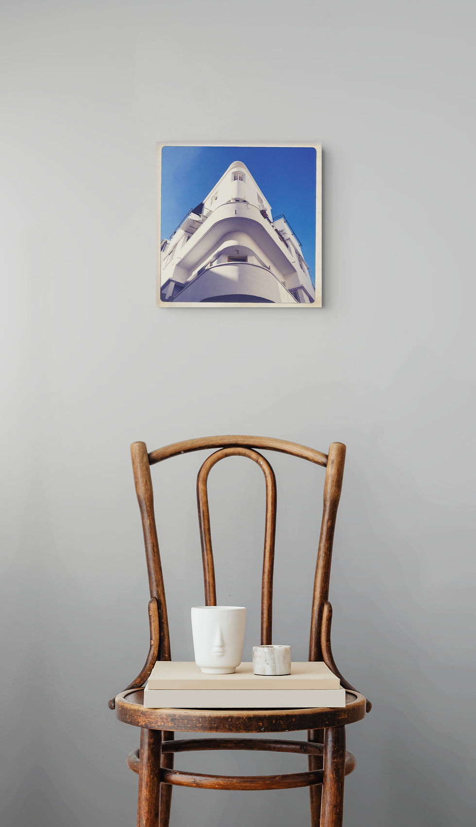 Bauhaus 8 art print above a chair with coffee cups.