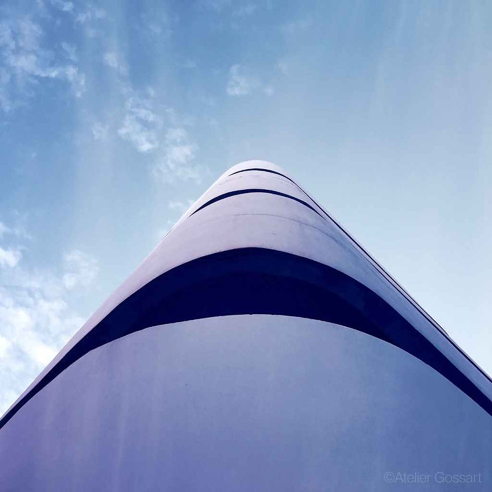 Bauhaus 5 modern curved architectural tower against blue sky
