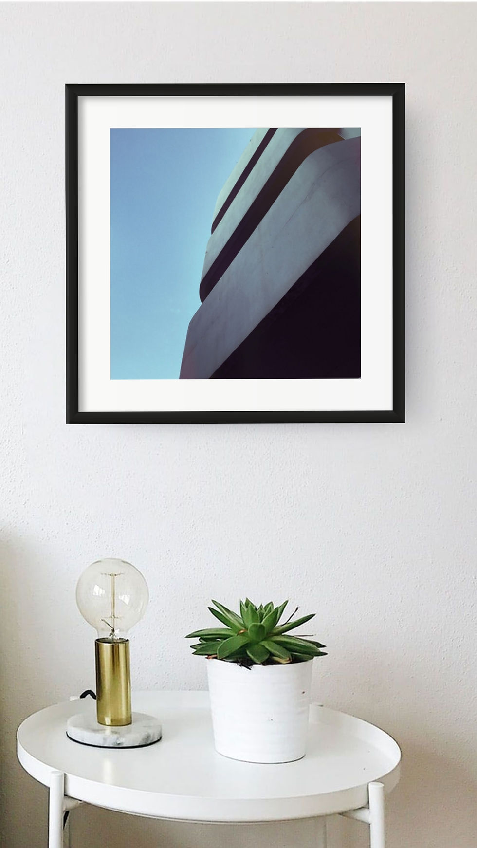 Bauhaus 2 architectural print above a white side table