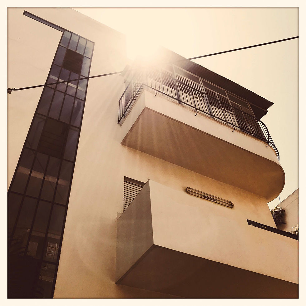 Bauhaus architecture building with sun flare and balconies