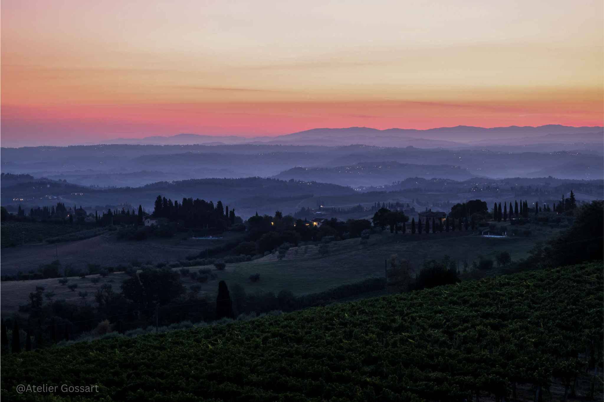 Tuscany by night: rolling hills at dusk with sunset sky.