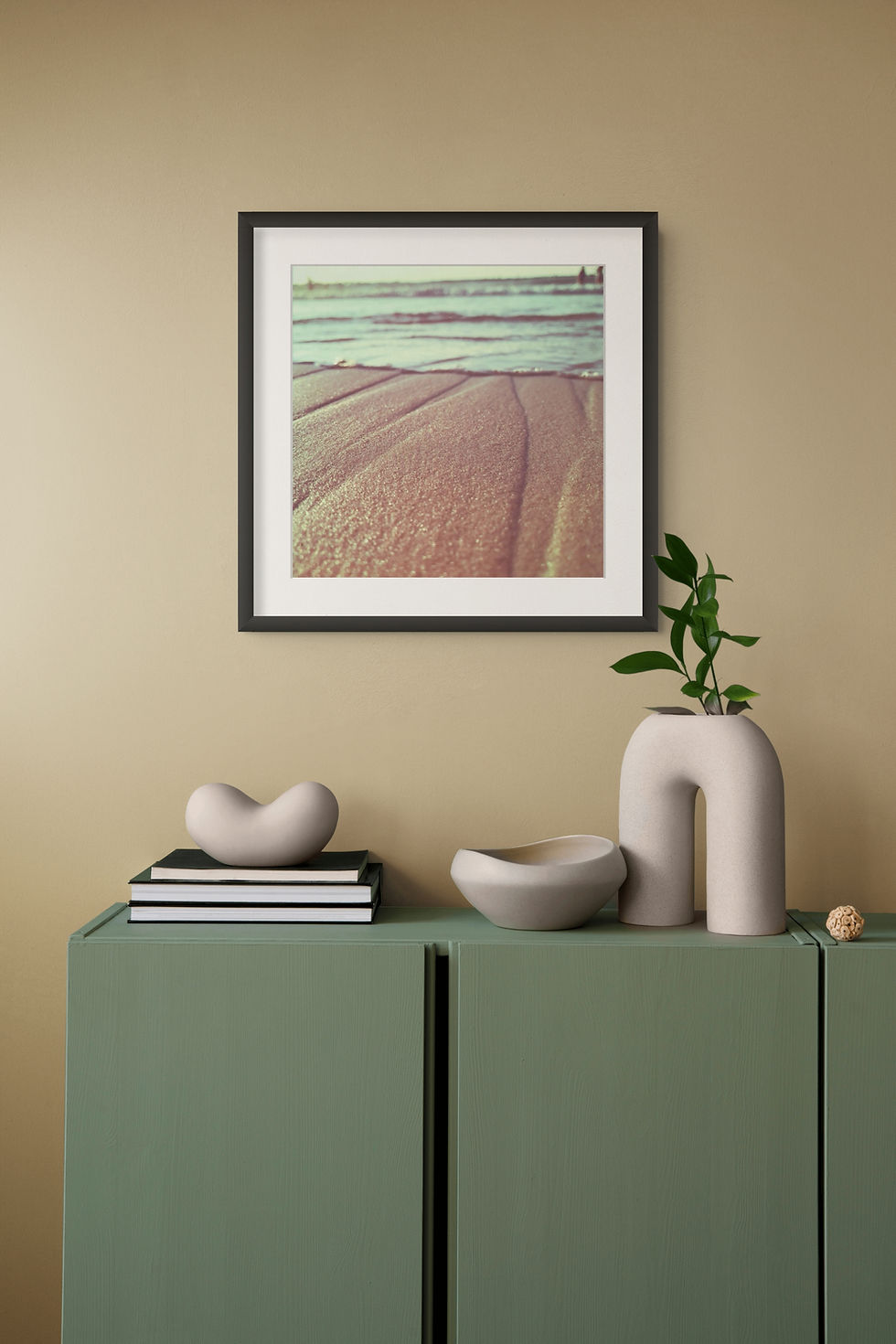 Frishman art print above green sideboard with vases