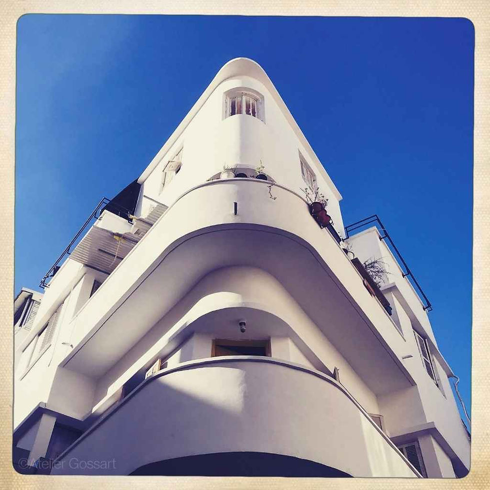 Low-angle view of white Bauhaus architecture in Tel Aviv