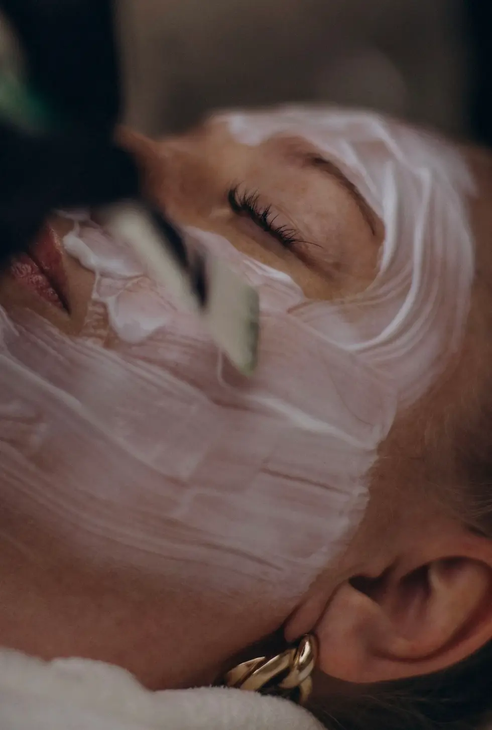 Client receiving professional acne treatment facial with mask application in London Ontario