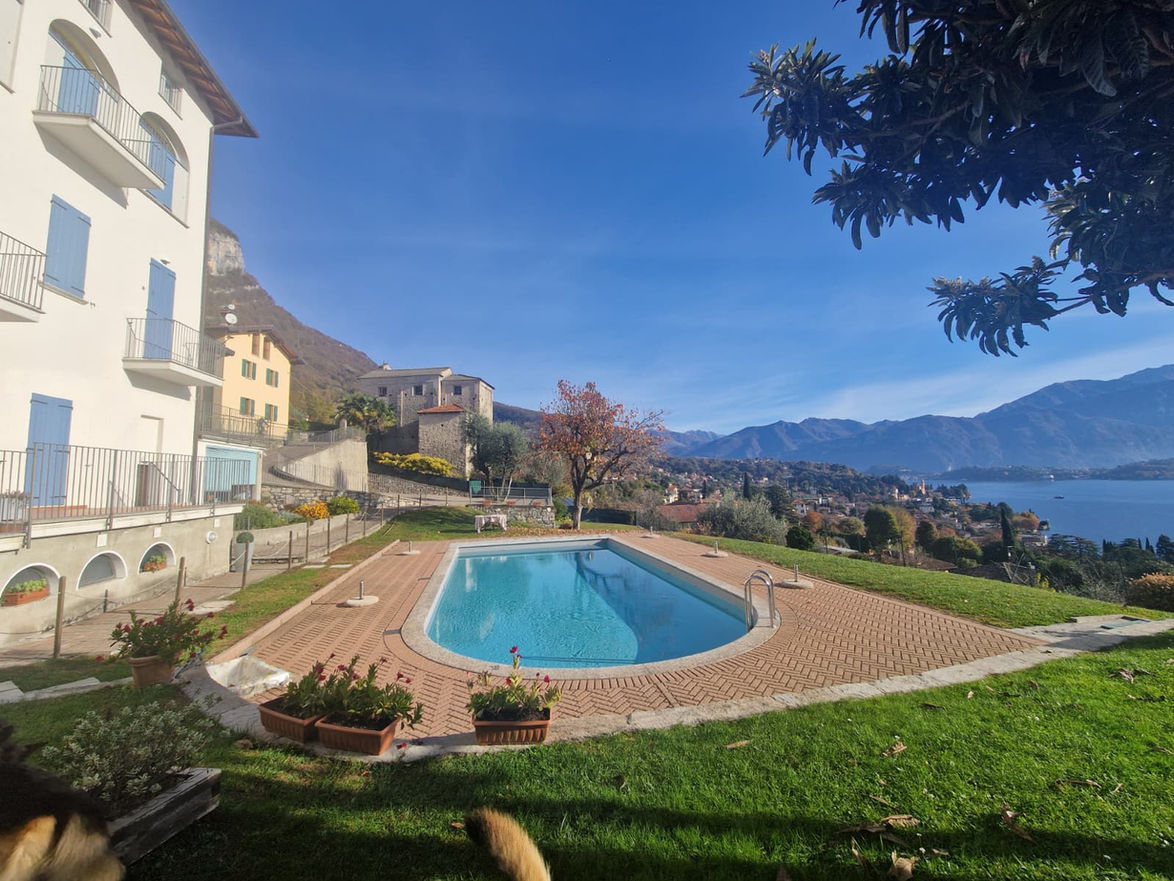 Luxury villa with swimming pool and panoramic view of Lake Como and the Tremezzina mountains under a clear blue sky