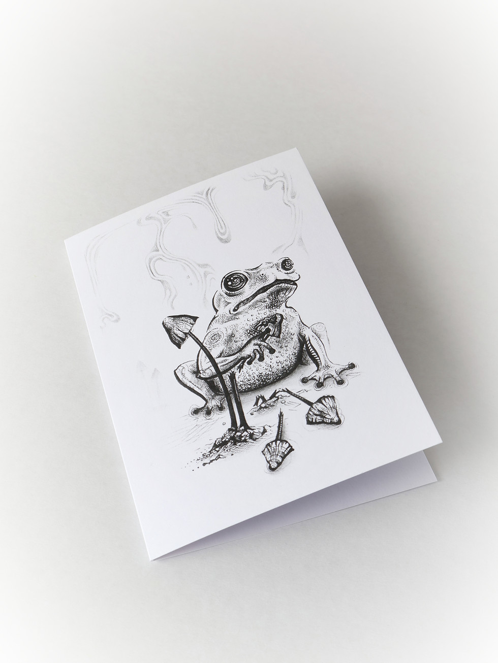 A greetings card created by New Zealand Artist Mikayla Forster. The card depicts a frog and mushrooms.