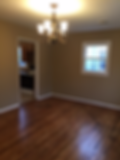 Thumbnail: an empty room with wooden floors and a light chandelier