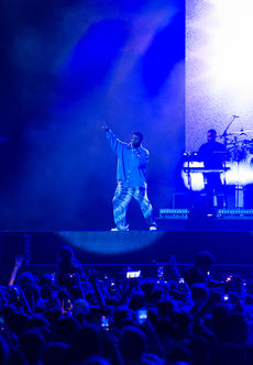 Khalid performing live on stage at the Abu Dhabi Formula 1 Grand Prix, engaging the crowd with his soulful presence.