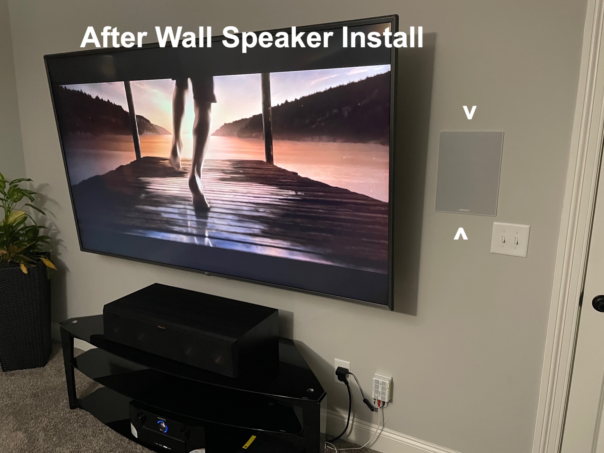 Wall-mounted TV with in-wall speaker installed beside it