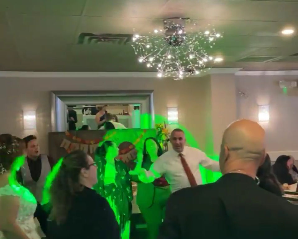 People dancing under green lights with a DJ at a party event DJJamesEntertainment