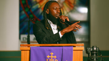 Man speaking from pulpit.