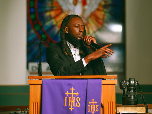 Man speaking from pulpit.