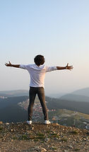 Young man on a top of a mountain
