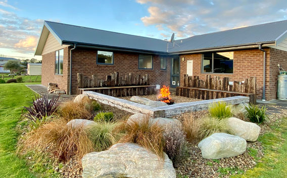 outdoor entertainment area, fire pit, seating, planting in christchurch