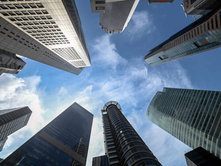 High-rise office buildings in Singapore’s central business district viewed from ground level.