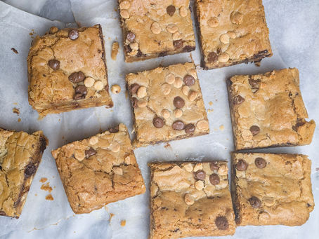 Squares of blondies on a piece of greaseproof paper