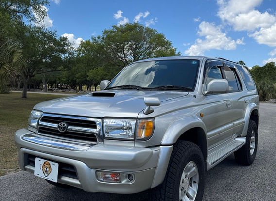 Front view of the 1999 Toyota Hilux Surf SSR-X showcasing full front glass headlamps, updated bumper, and fog lamps.