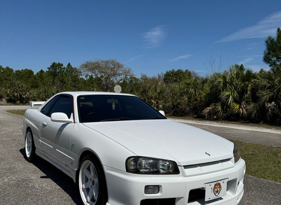 Front view of the Nissan Skyline R34 GTT showcasing its factory Xenon headlights and iconic JDM styling.