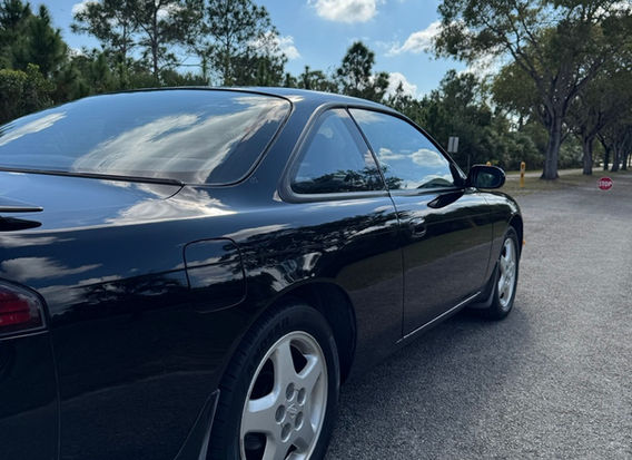 Side profile of 1994 Nissan Silvia S14 – clean original condition with 5-lug conversion.