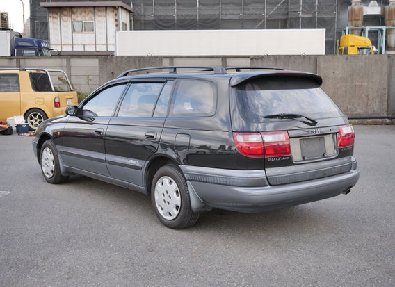 Rear view of 1994 Toyota Caldina TZ 4WD in black/gray two-tone with clean taillights and factory badging.