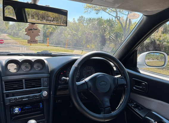 Interior of the 1998 Nissan Skyline R34 GTT showcasing factory 'Skyline' carpets and original trim.