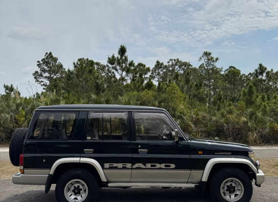 Rare 1995 Toyota Land Cruiser Prado SX Wide with a legendary 1KZ-TE 3.0L turbo diesel engine, selectable 4WD, factory graphics, and a well-preserved interior. Now for sale at LION JDM IMPORTS LLC with nationwide shipping options.