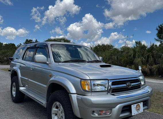 Front view of the 1999 Toyota Hilux Surf SSR-X showcasing full front glass headlamps, updated bumper, and fog lamps.