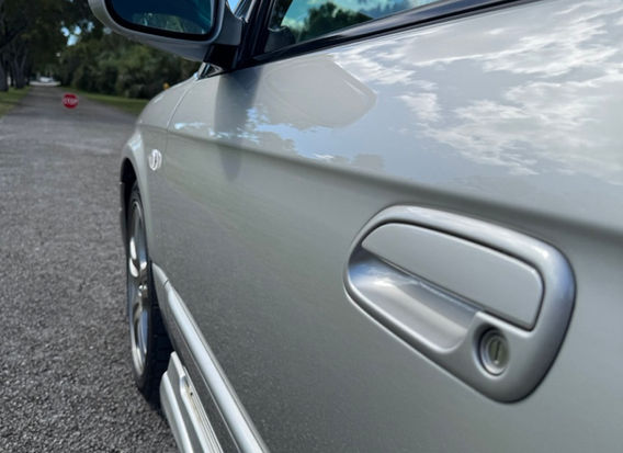 Side profile of 2000 Subaru Legacy GT-B E-Tune wagon — one-owner twin-turbo AWD with Bilstein sport suspension.