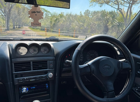 Interior of the 1998 Nissan Skyline R34 GTT showcasing factory 'Skyline' carpets and original trim.