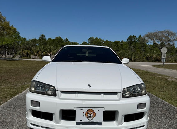 Front view of the Nissan Skyline R34 GTT showcasing its factory Xenon headlights and iconic JDM styling.