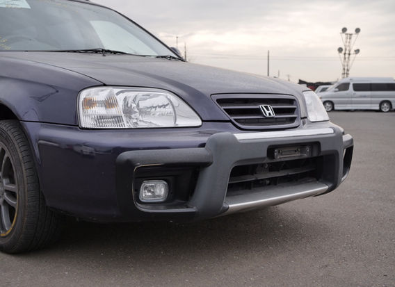 1996 Honda Orthia 2.0GX 4WD front view in original navy paint with clean headlights and alloy wheels.