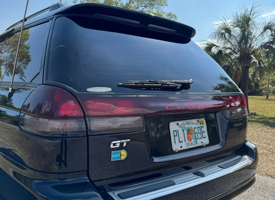 The rear of a 1996 Subaru Legacy Wagon GT-B, highlighting its wagon design, taillights, and subtle rear spoiler.