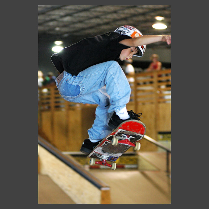 young skateboarder flying off ramp