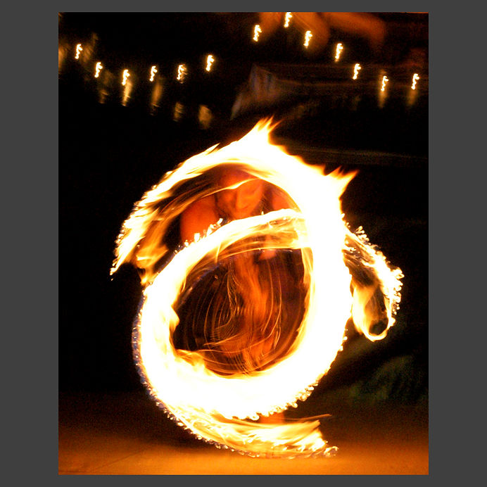 fire dancer with tracers from slow shutter