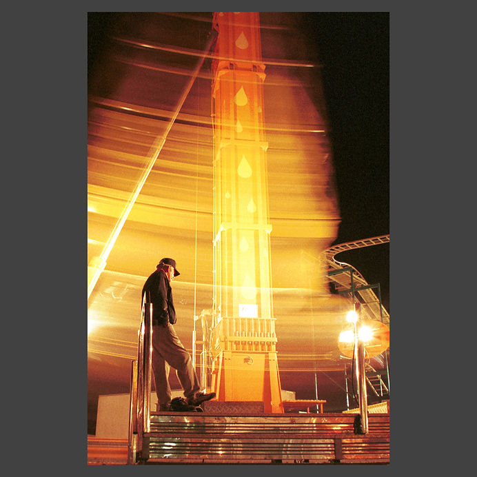 slow shutter photography of a ride attendant at night